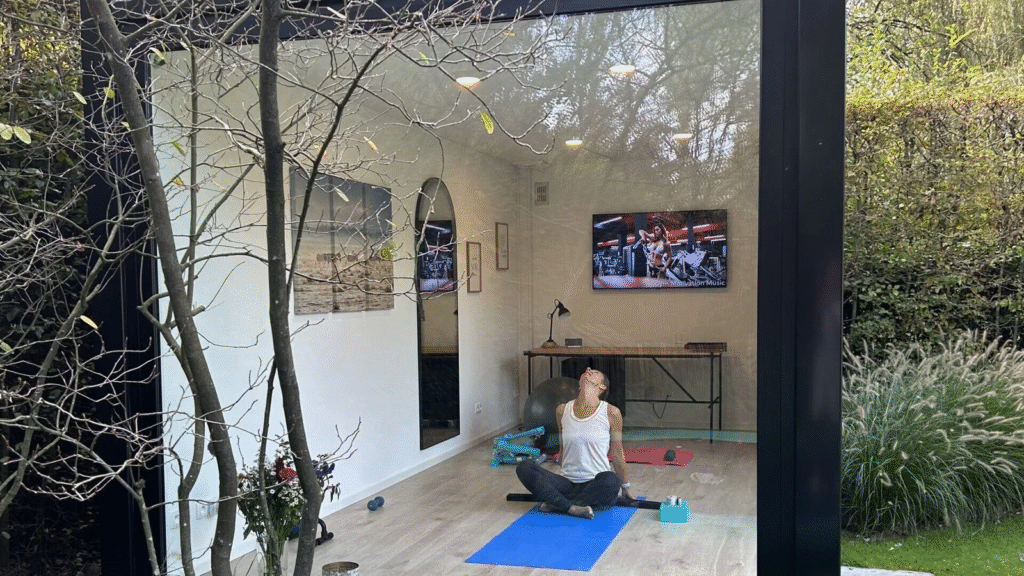 Vrouw die yoga doet op blauwe yogamat in modulaire unit